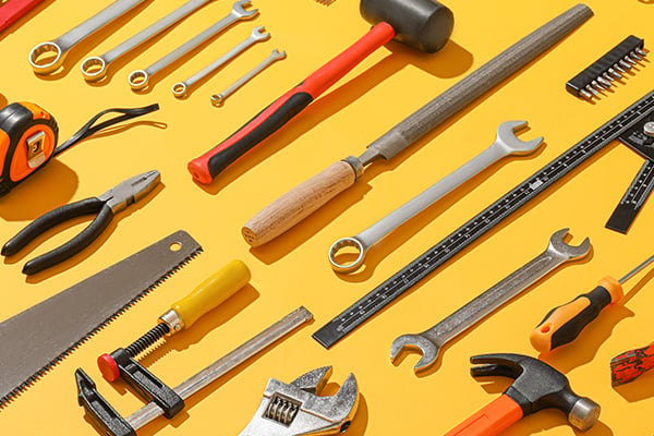 BLD Blog Role of DIYers list of tools arranged with wrenches hammers and tape measure