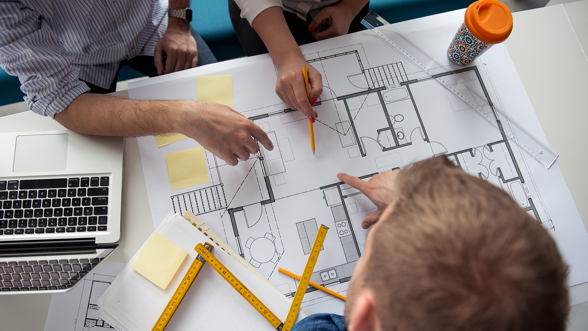 Architects reviewing building product specifications and blueprints